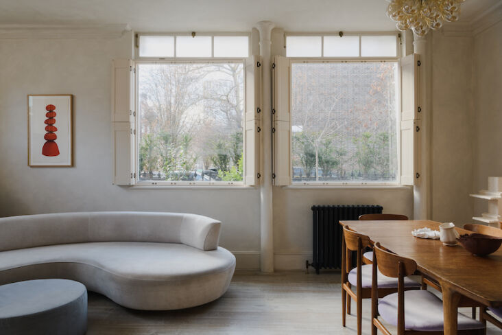 A clean, minimalist living and dining area with neutral tones and open layout.