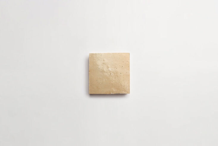 Close-up of handmade Zellige Moroccan square tiles in a neutral sand color.