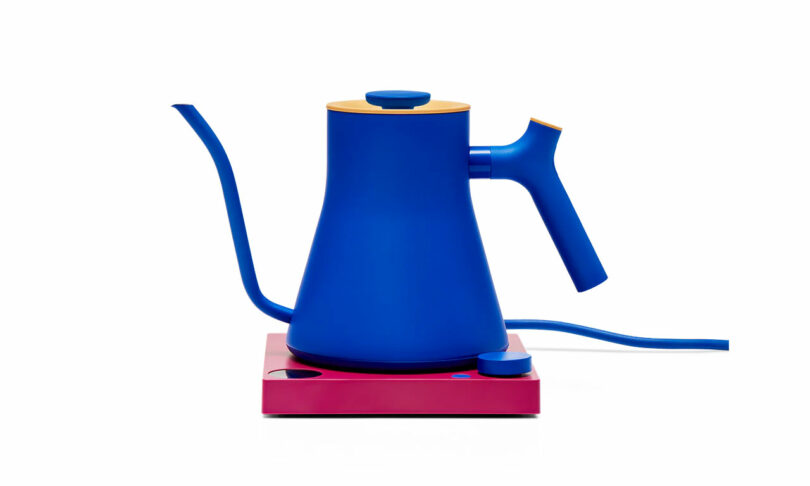 A colorful blue electric gooseneck kettle with a pink base and yellow handle accents.