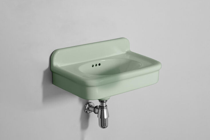 A retro-style wall-hung blue basin with colorful spherical legs.