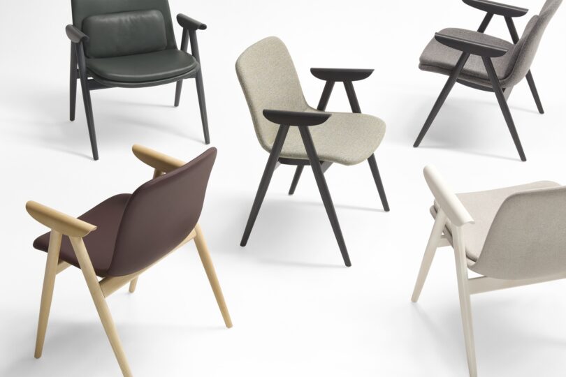 An array of Keilhauer chairs in different colors and wood finishes arranged on a white background.