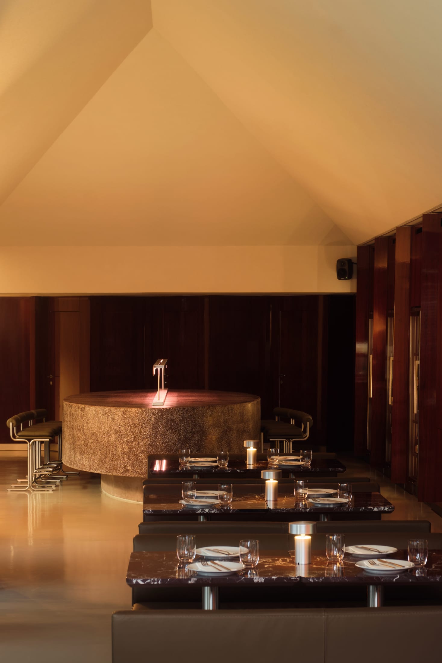 A minimalist, high-concept bathroom with monolithic stone sinks and integrated lighting.