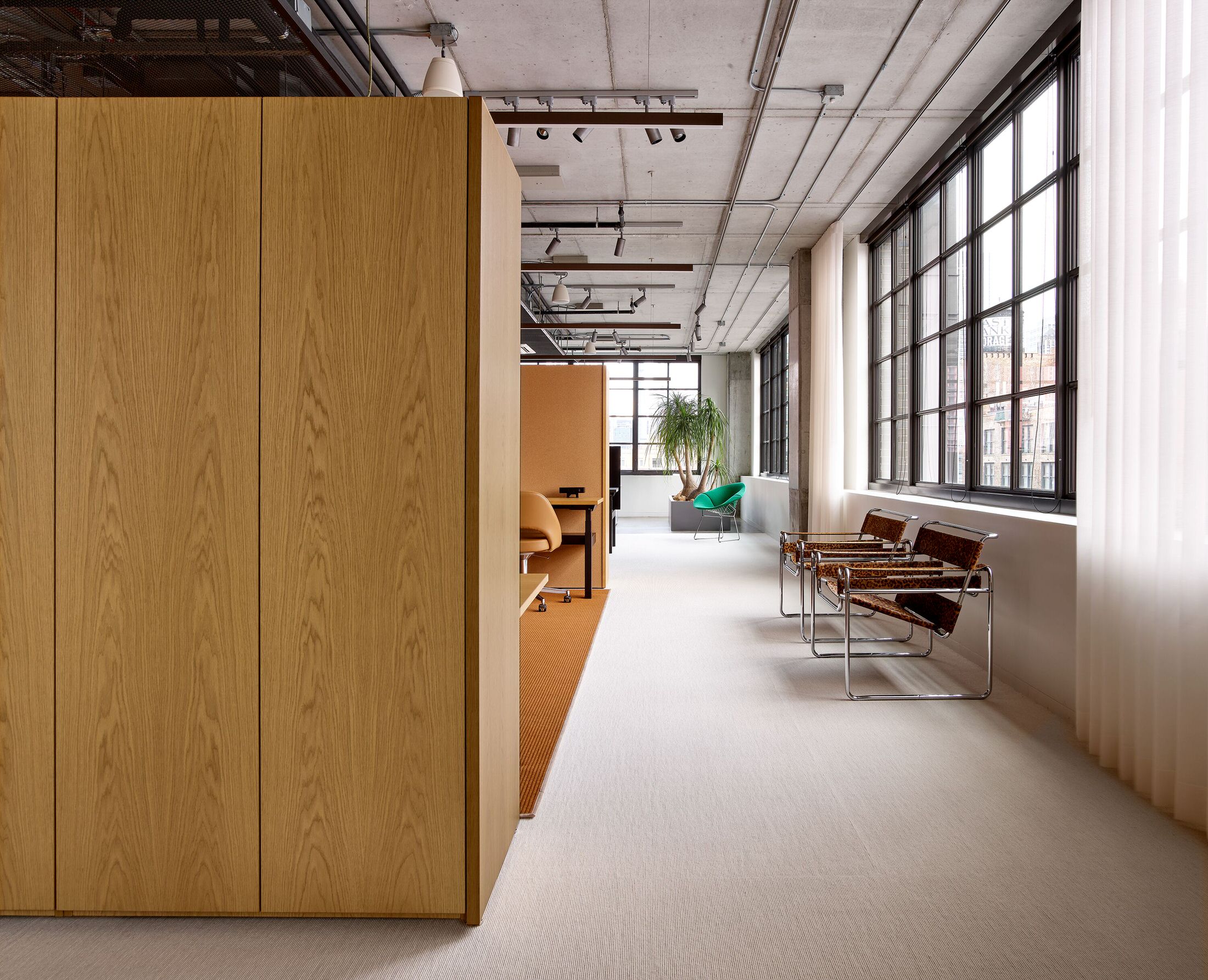 Interior view of the Knoll Chicago Showroom featuring a variety of modernist furniture arrangements.