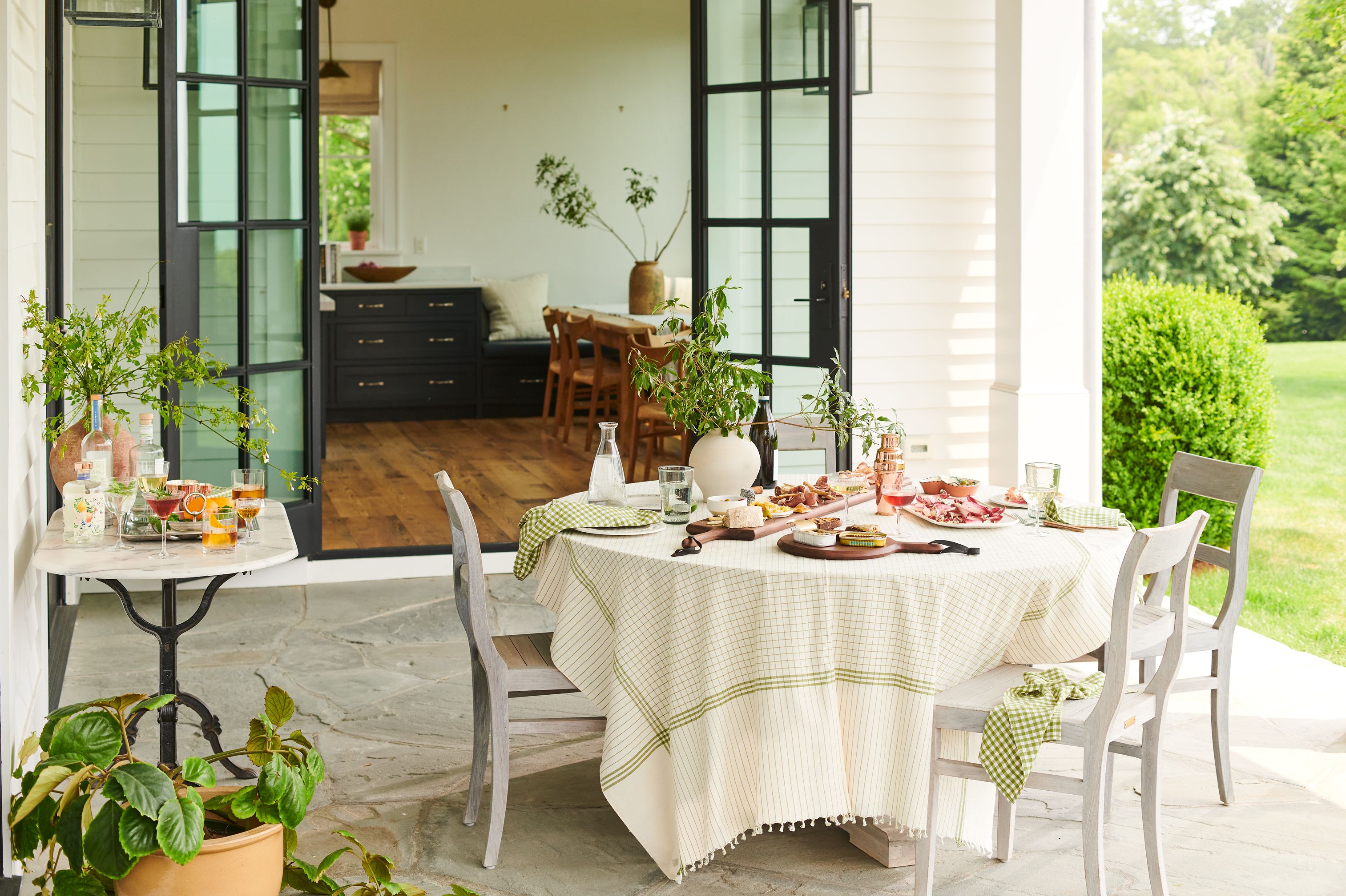 Text overlay '3 Fresh Ways to Rethink Outdoor Entertaining' over a blurred background of a summer party.