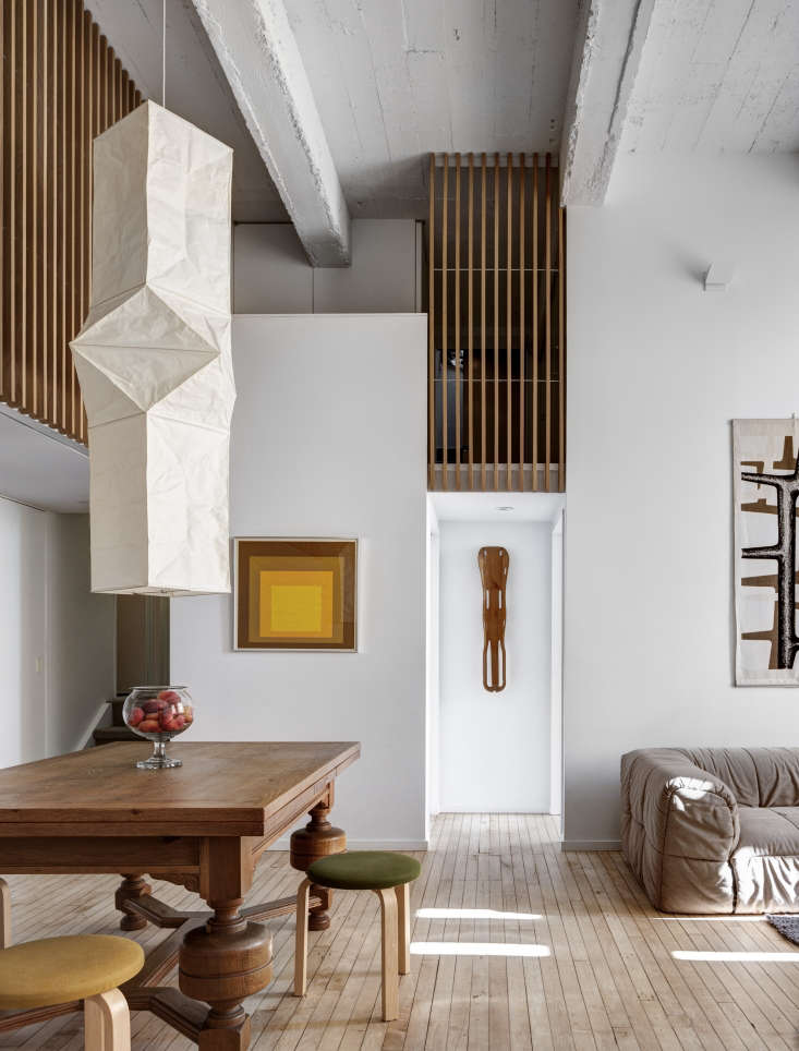 An oblong Akari Ceiling Lamp Model L5 hanging in a lofty Brooklyn living room.