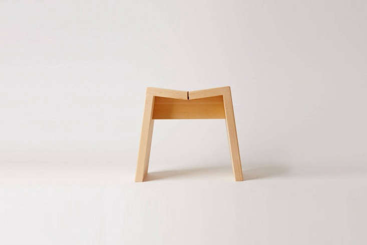 A minimalist hinoki wood bath stool with clean lines.
