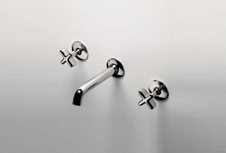 A low-profile three-hole wall-mounted faucet with cross handles in a metallic finish.