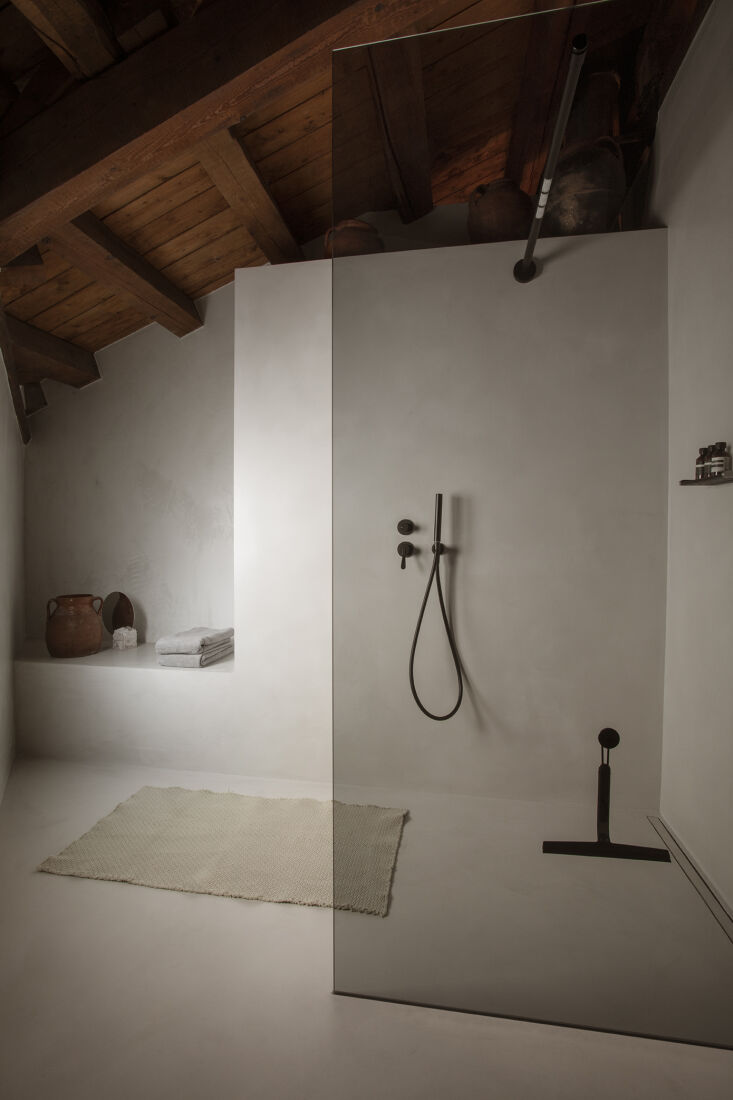 A minimalist seamless shower setup in a mountain hideaway.