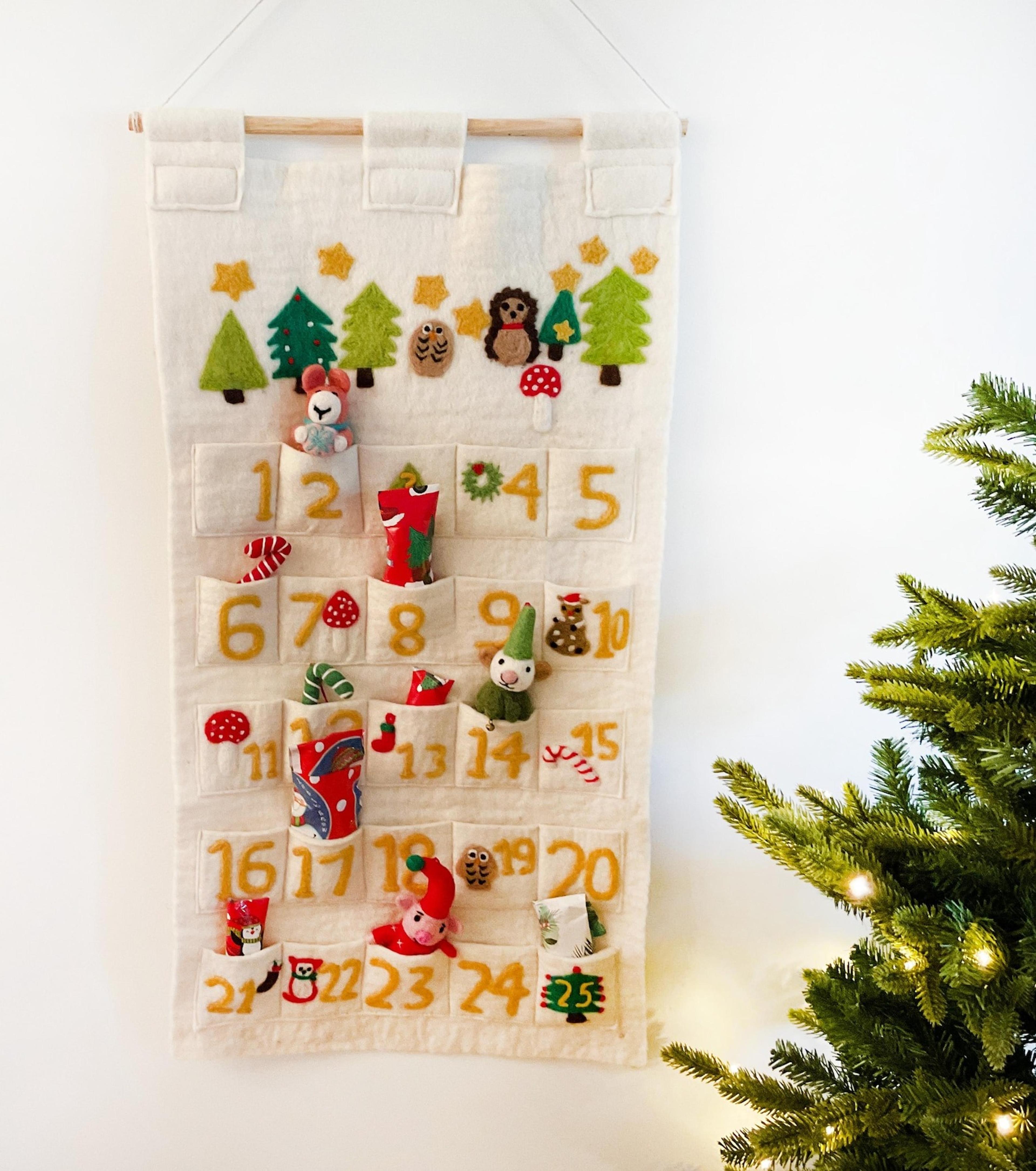 A minimalist grey felt advent calendar with numbered pockets and wooden accents.