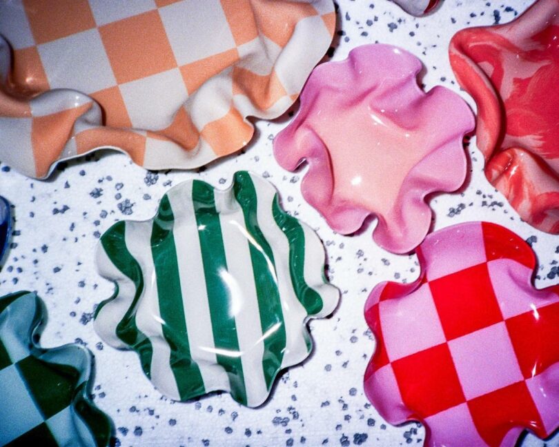 Vibrant ceramic bowls with wavy edges and bold checkered patterns.
