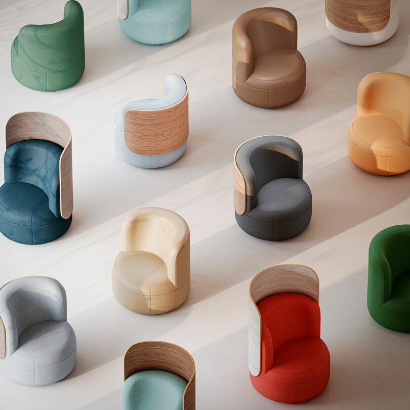 Top-down view of rows of curved Dotti armchairs with wooden backs in various colors.