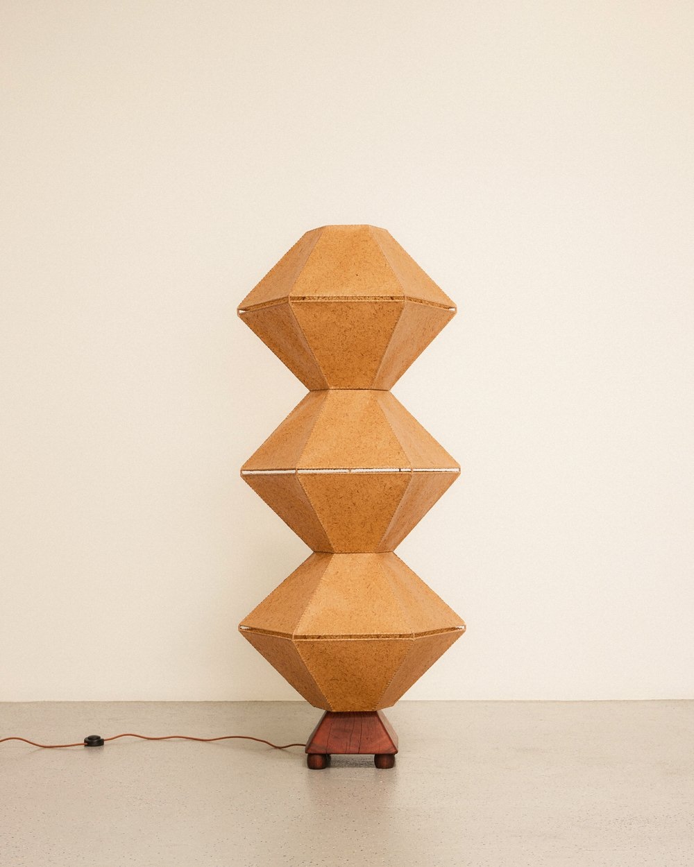 Close-up of the Cells floor lamp featuring beeswax-soaked mulberry bark shades with a warm, organic glow.