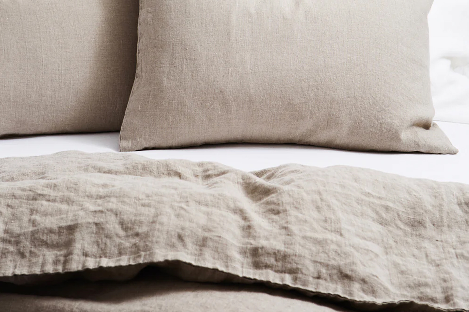 Natural linen duvet cover and pillowcases in a soft beige tone.