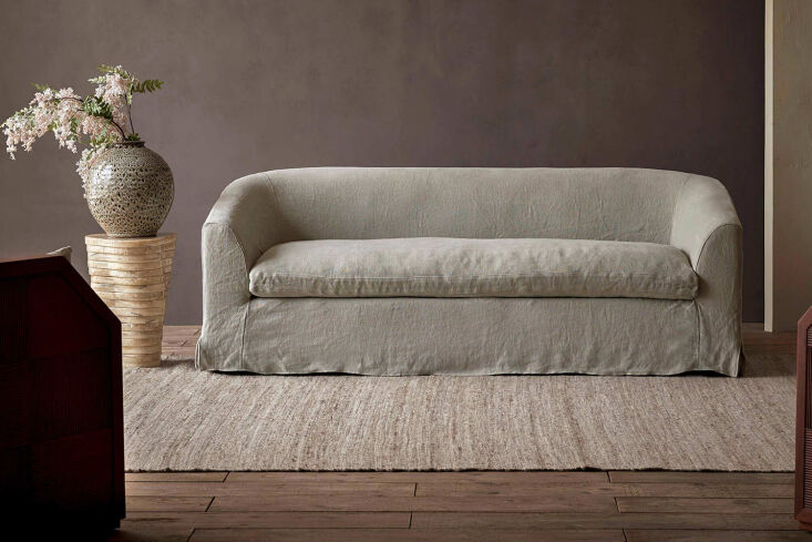 The Six Penny Ziki Sofa featuring sloped arms and a soft, upholstered look.