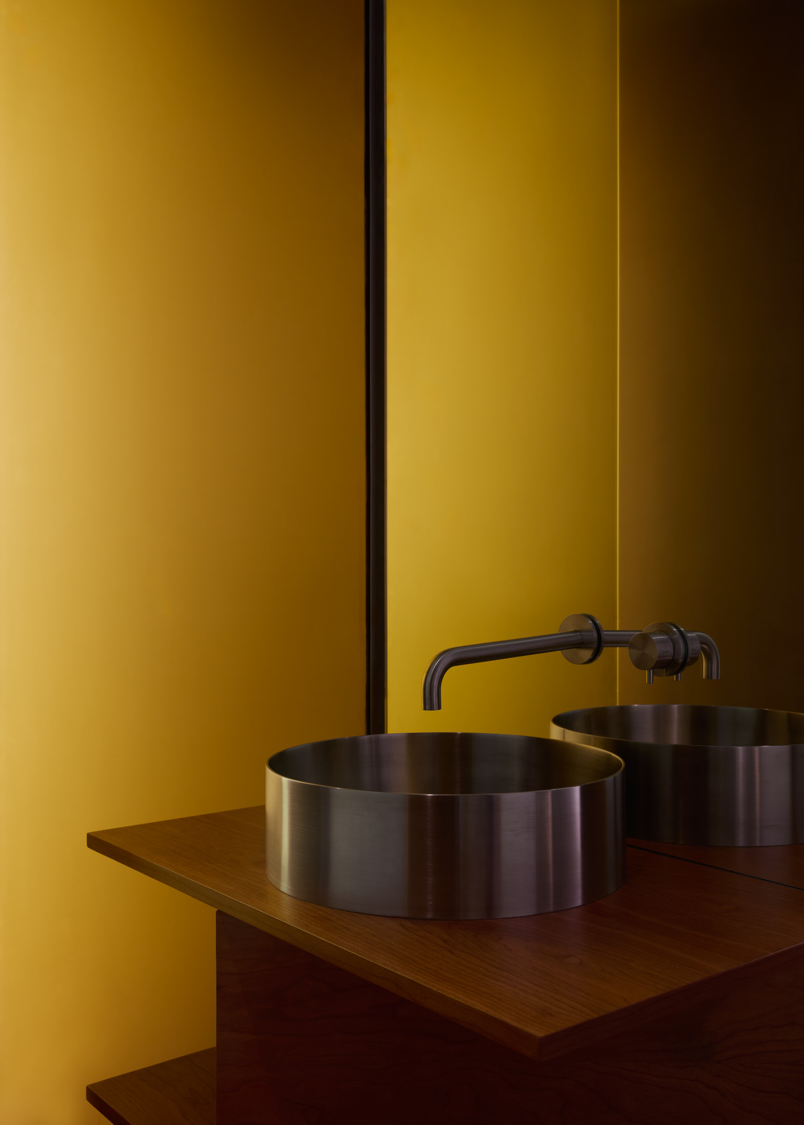 Close-up of a pendant light hanging over a dining area with textured walls.