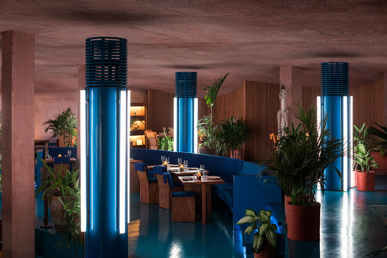 Guests dining in the round within the textured, dome-shaped interior of the restaurant.