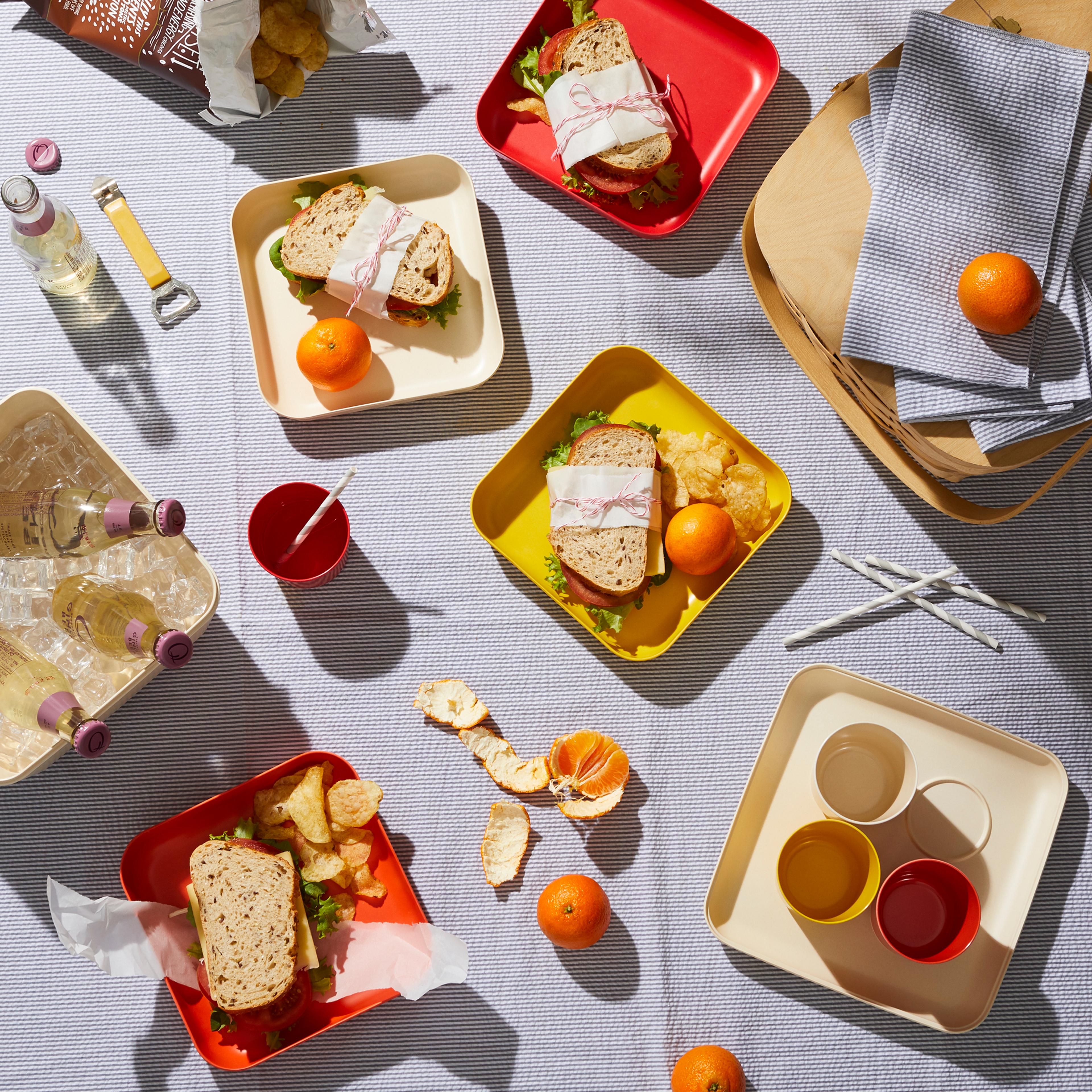 Well-prepared sandwiches laid out neatly on a clean picnic blanket.