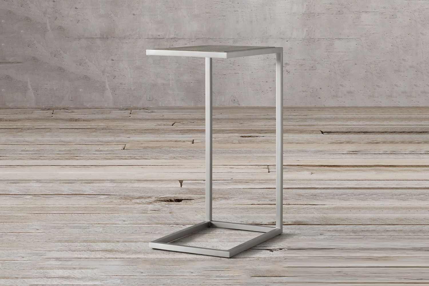 Industrial style C-table with a rectangular metal frame on a weathered wood floor.