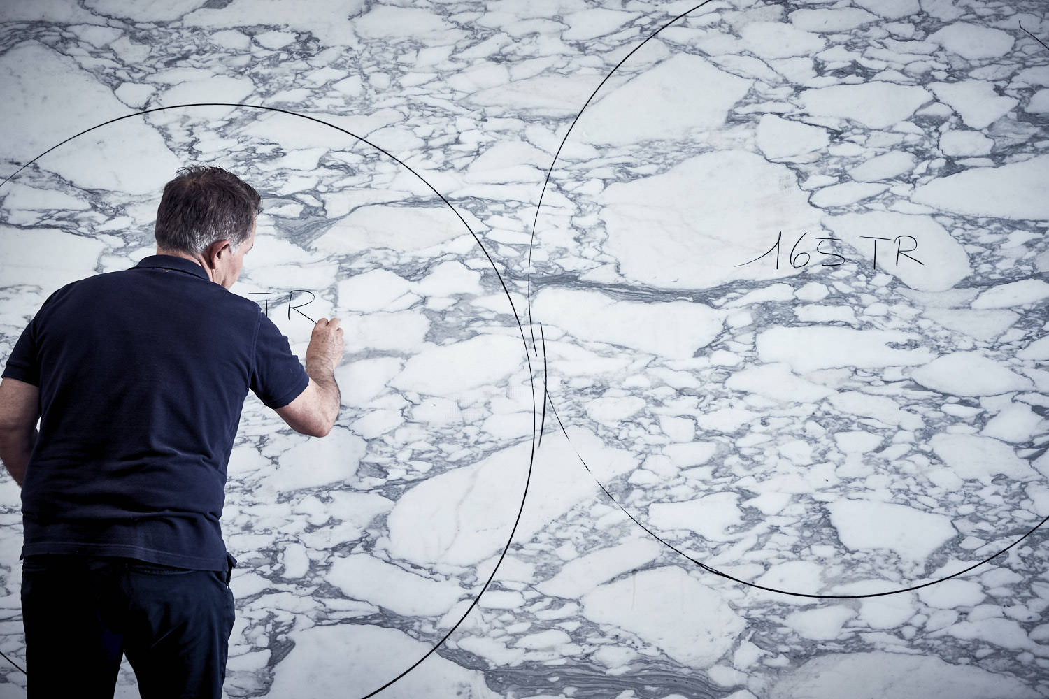 Close-up detail of a high-grade white marble slab with distinct grey veining.