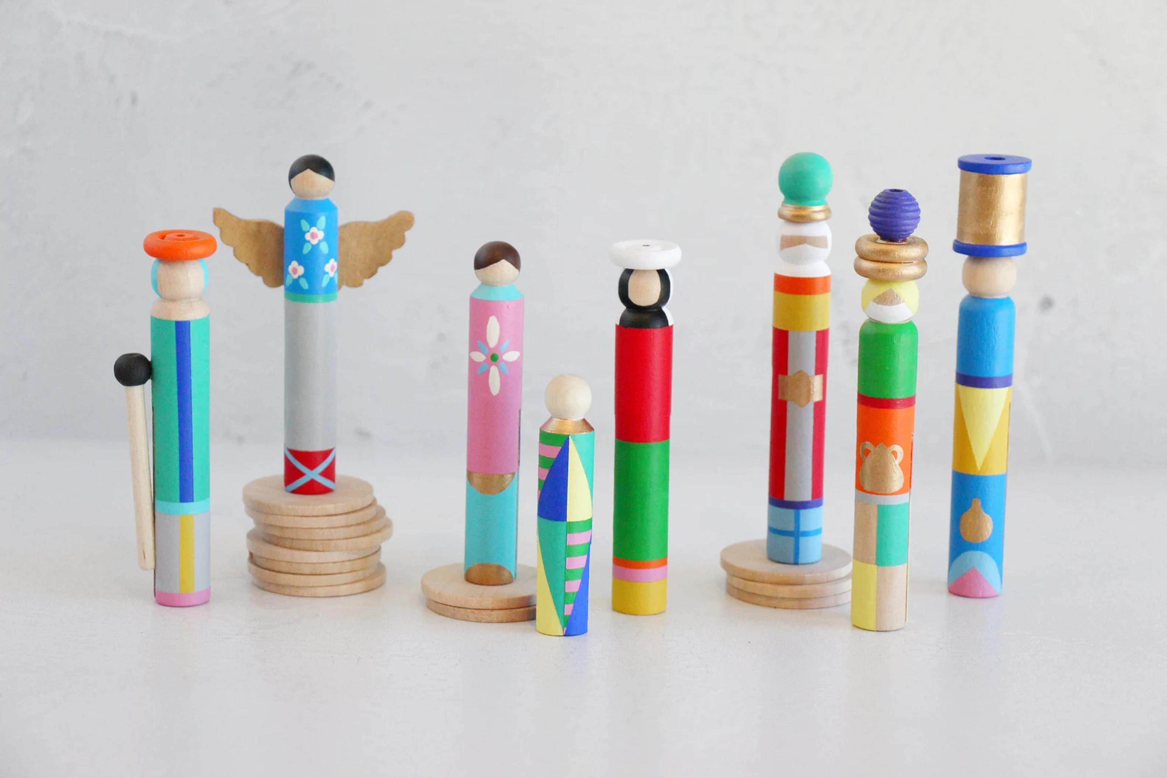 A minimalist nativity scene made from hand-painted wooden clothespins.