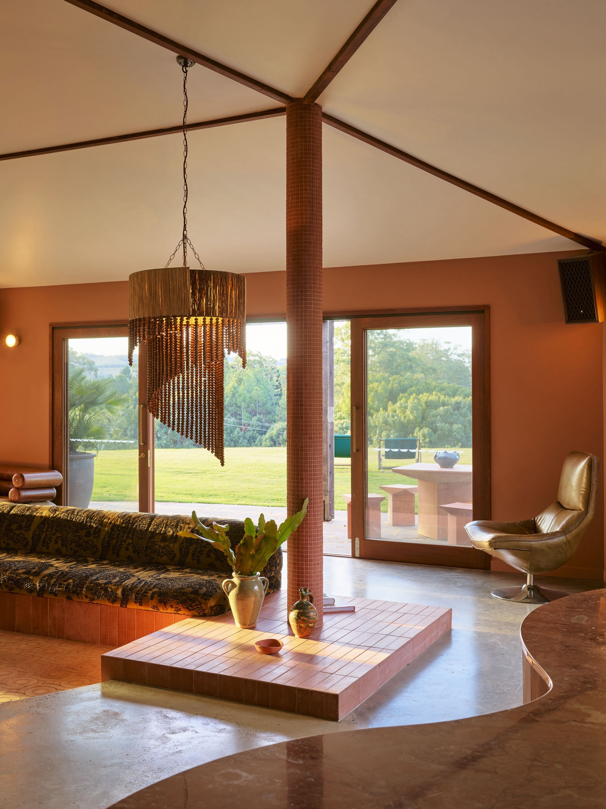 A large sculptural pendant lamp hanging in a lounge area at Sun Ranch, Byron Bay.