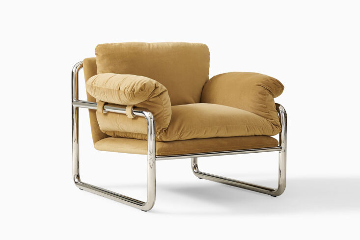 The West Elm Desmond Chair featuring a slender chrome exterior frame and soft, slouchy cushions.