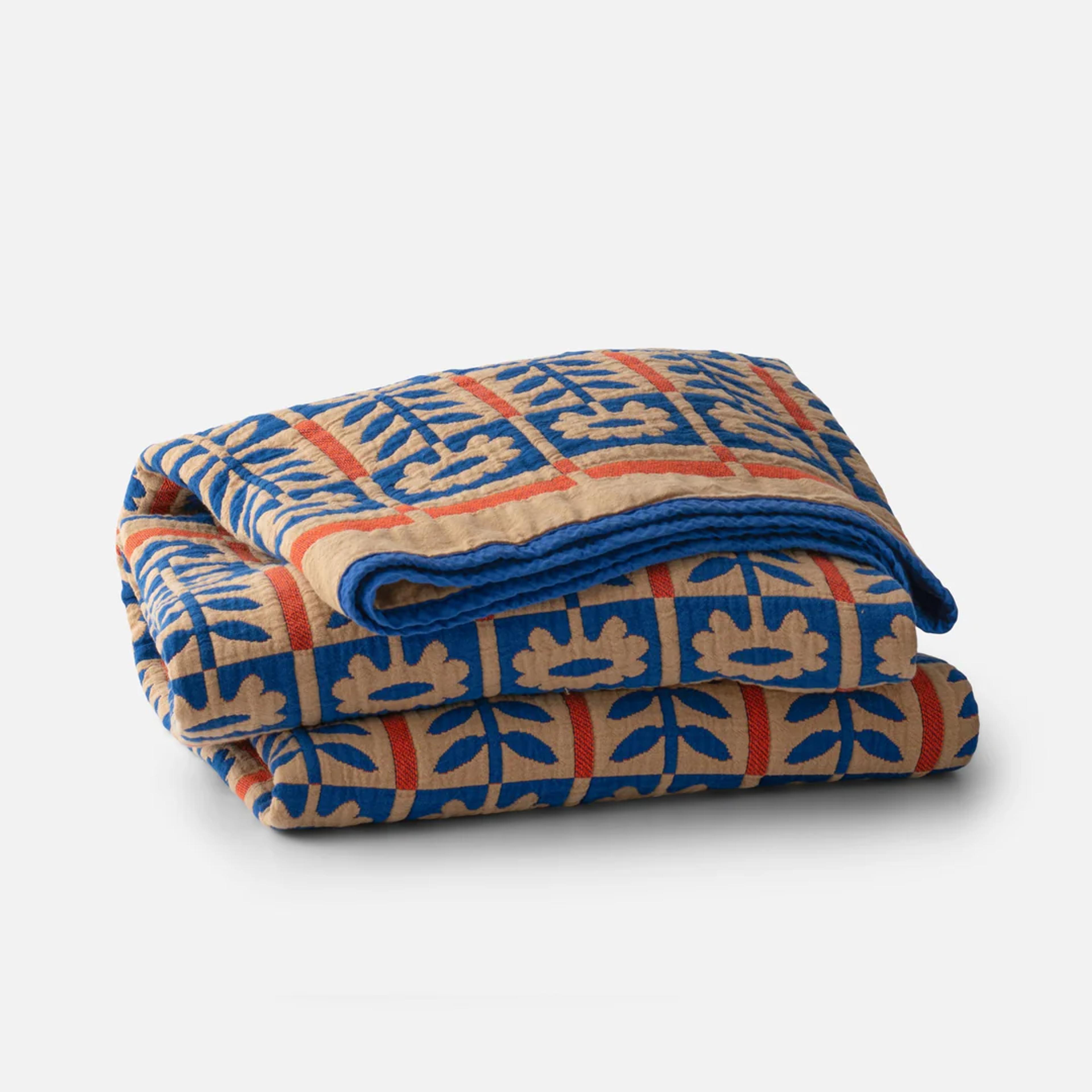 The Schoolhouse Stillwater Quilt featuring a classic gridded pattern and soft texture.