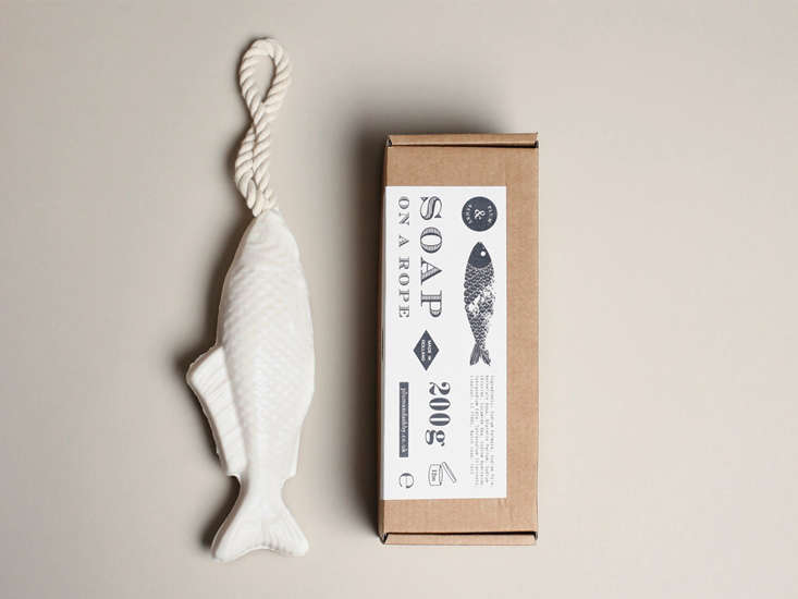 A Japanese-inspired fish-shaped soap on a rope hanging against a white background.