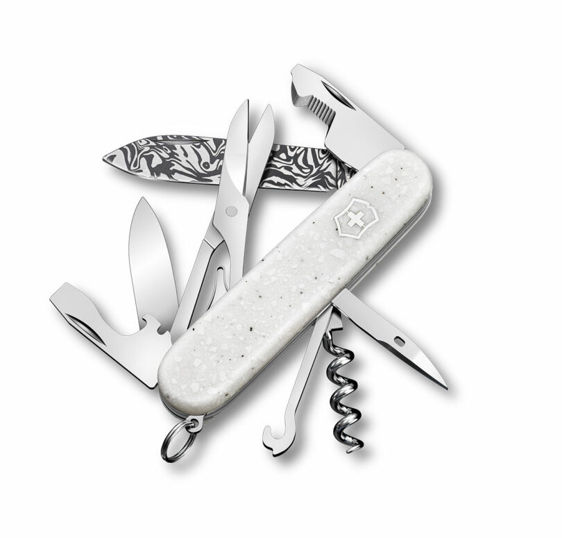 Victorinox Swiss Army knife with multiple tools extended, showcasing the wavy Svavner steel pattern on the main blade.