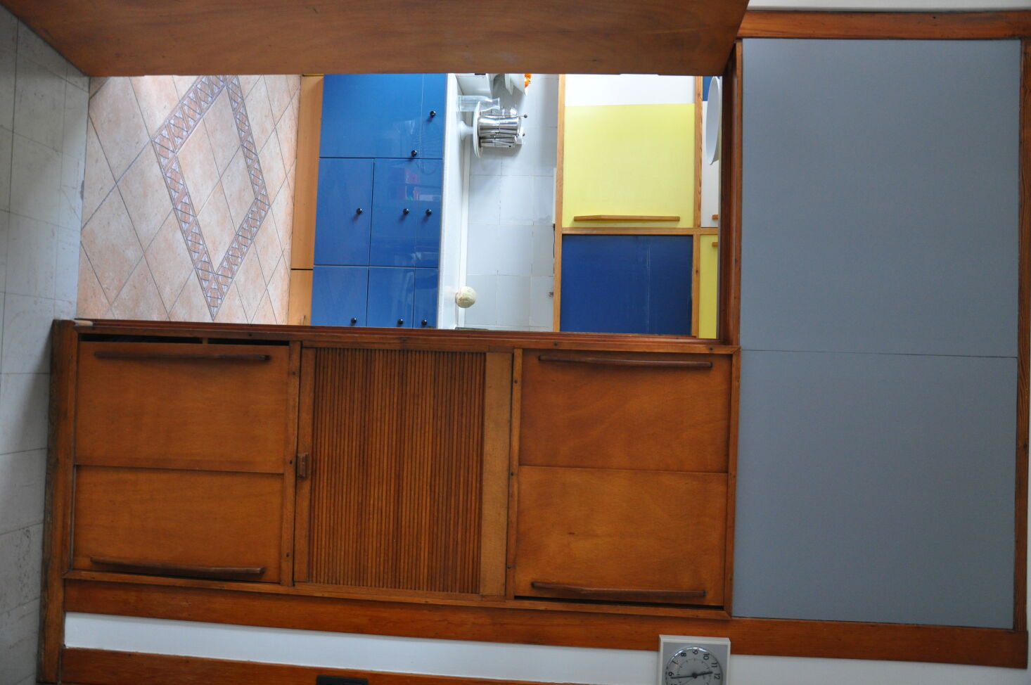A 'before' photo of the Moreau House kitchen showing dated flooring and non-original lower cabinets.