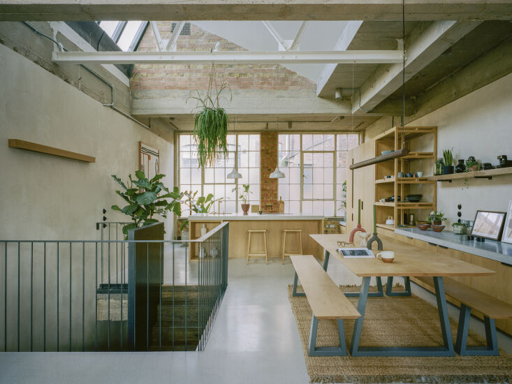 Architectural view of a renovated loft showing a reorganized layout with distinct zones for work and rest.