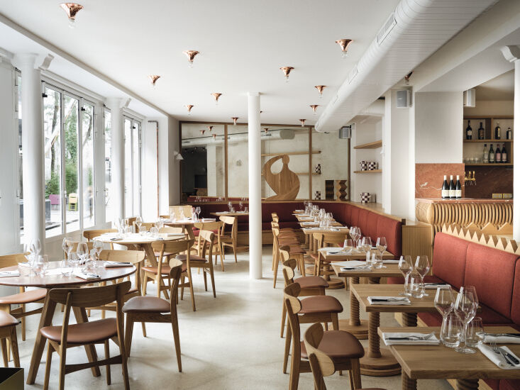 A ceiling filled with small copper constellation-style light fixtures.