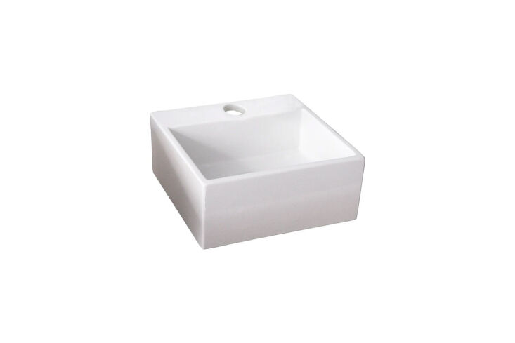 A small square ceramic sink designed to fit into a 90-degree wall corner.