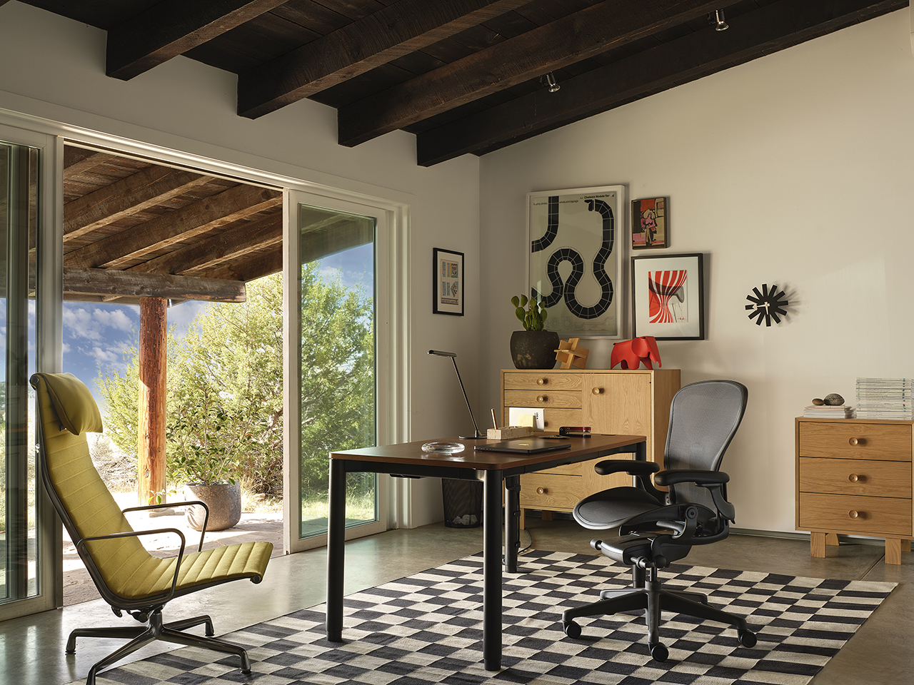 Herman Miller Spout Sit-to-Stand Table in a minimalist setting.