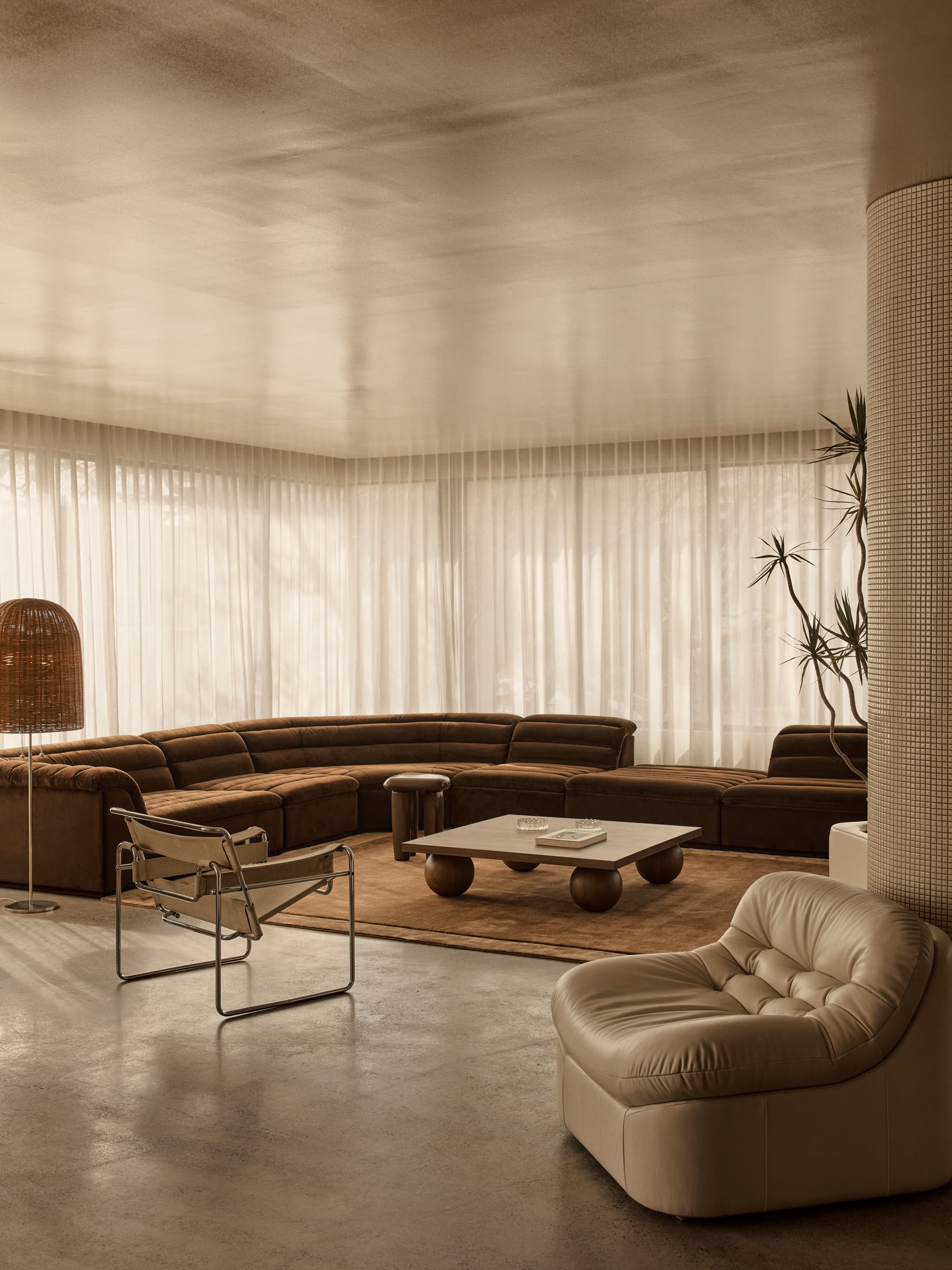 A high-end travertine and oak ping pong table set in a modern showroom environment.