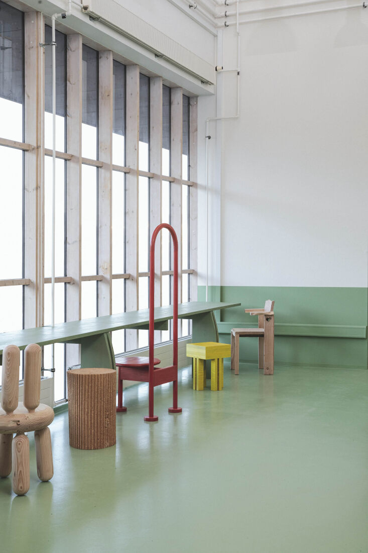 A close-up of Ari Prasetya's bar desk and chairs made from Douglas Fir offcuts, showing natural wood textures.