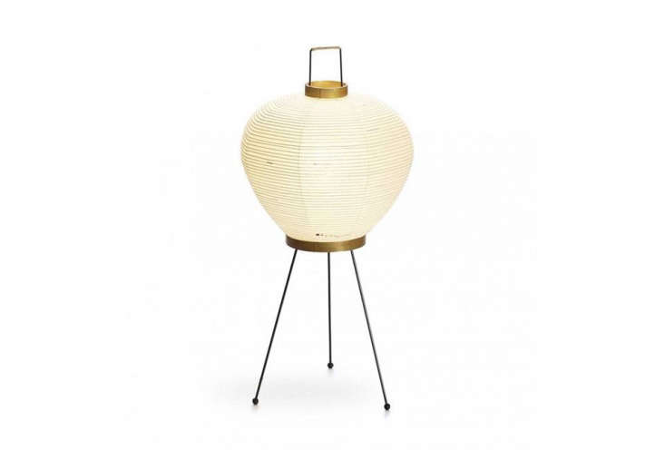The Noguchi Akari Floor Lamp Model 3A with its distinct three-legged metal stand.