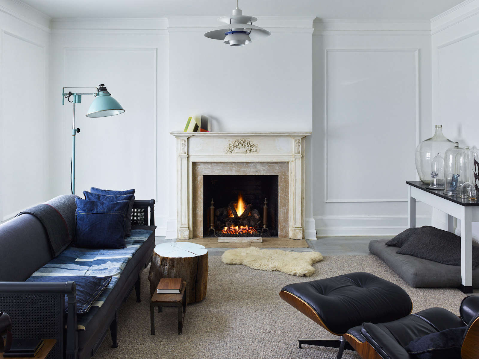 Living room view showing layered carpeting, a sheepskin rug, and small side tables.