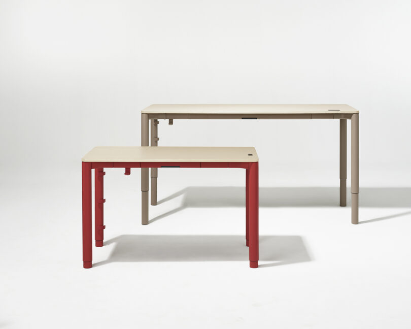 Two versions of the Spout table: one with red legs and one with beige legs, showing different height settings.