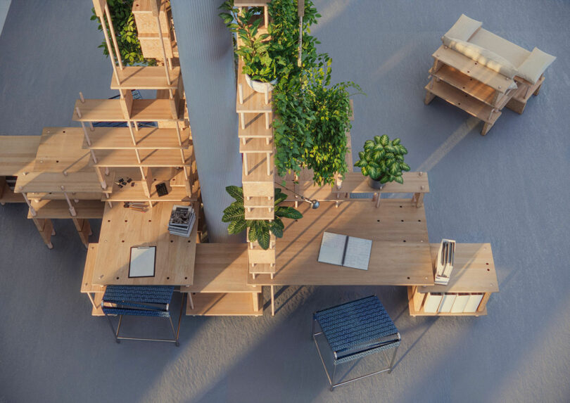 Overhead view of a modular wooden office system with plant shelves and integrated desk storage.