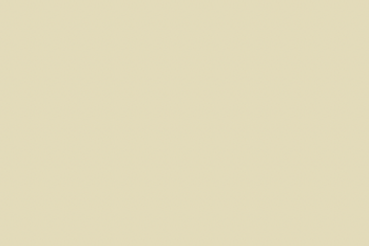 Close-up of bedroom walls painted in textured limewash paint in an earth tone.