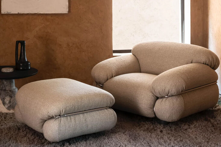 A Tacchini Sesann Armchair with a distinctive wraparound chrome frame and chunky designer upholstery.