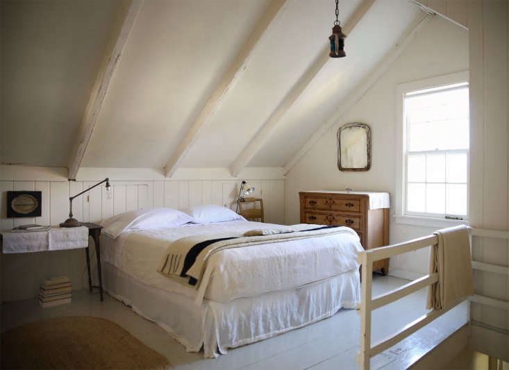 A bed made with Sferra sheets featuring clean square corners and a neat turndown.