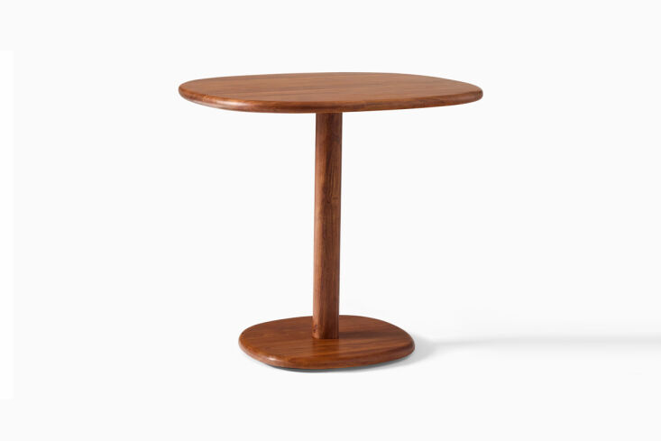 The Mosco Bistro Table with a dark top and minimalist base.