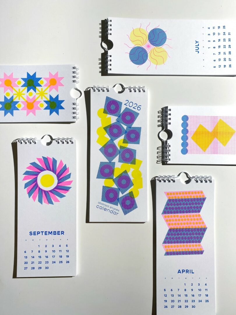 An array of desk calendar pages featuring colorful geometric patterns for various months.