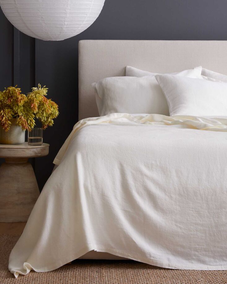 An ivory-colored Vintage Wash European Bed Cover from Quince on a neatly made bed.