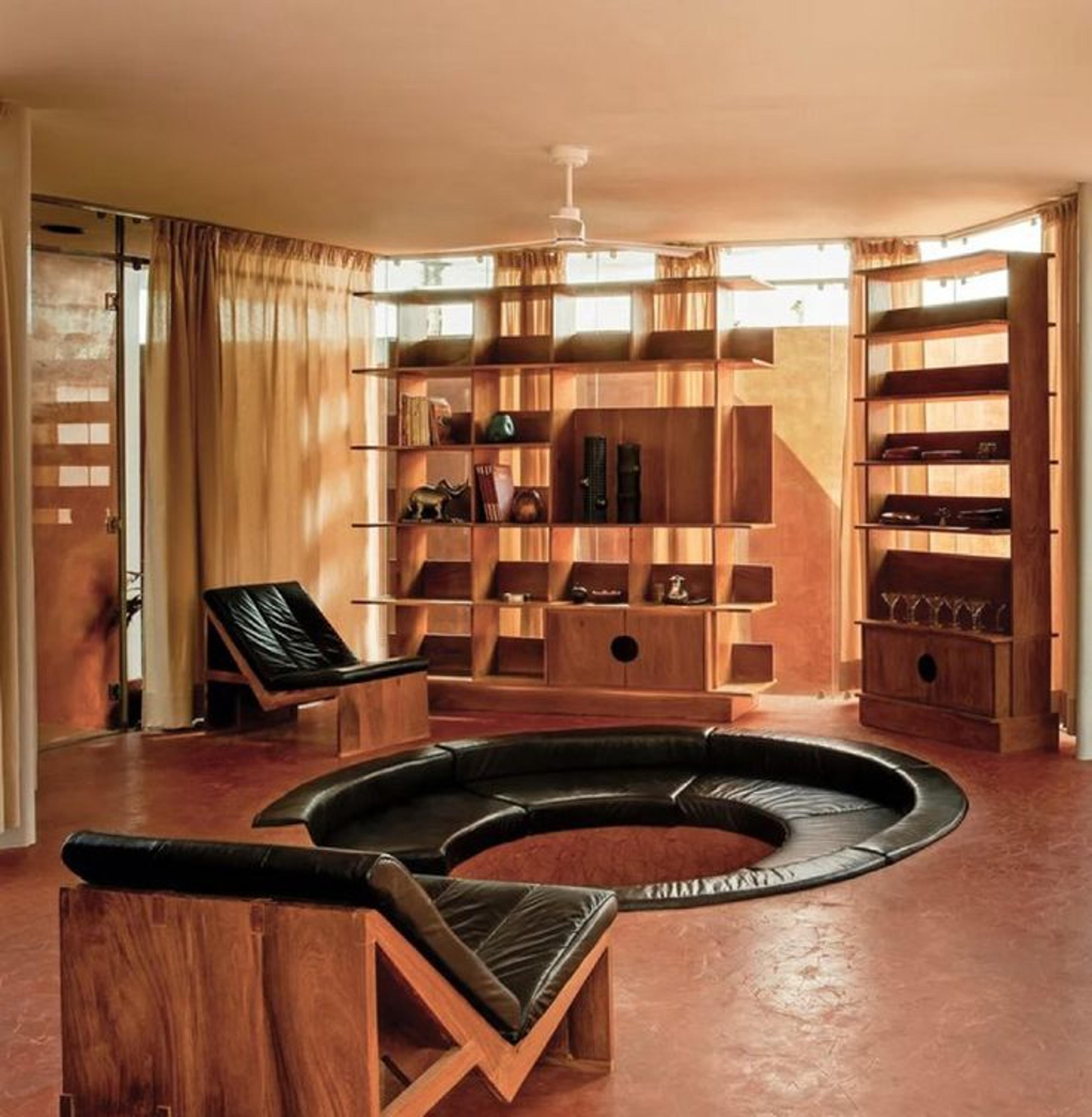 A modern sunken living room with plush seating and architectural depth.