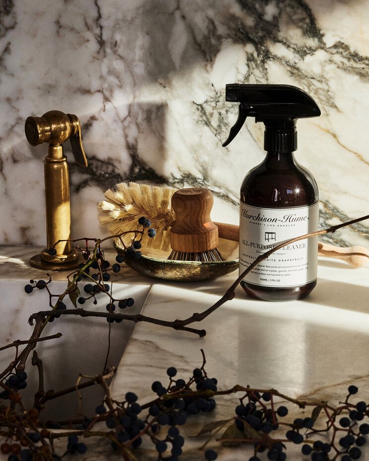 Athena Calderone's kitchen featuring aesthetic cleaning products on a marble countertop.