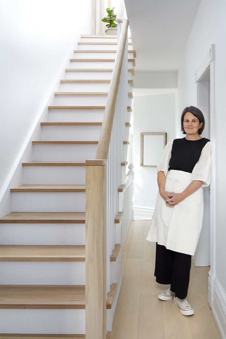 Heather Shaw standing in the second-floor hallway of her Victorian home.