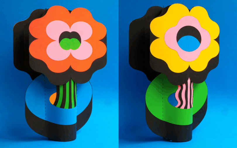 Two stylized paper flowers with bold patterns against a blue background.
